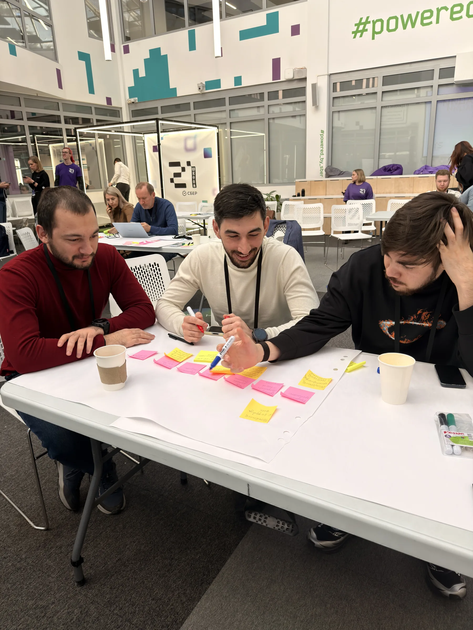 School 21 workshop participants developing a prototype at a table